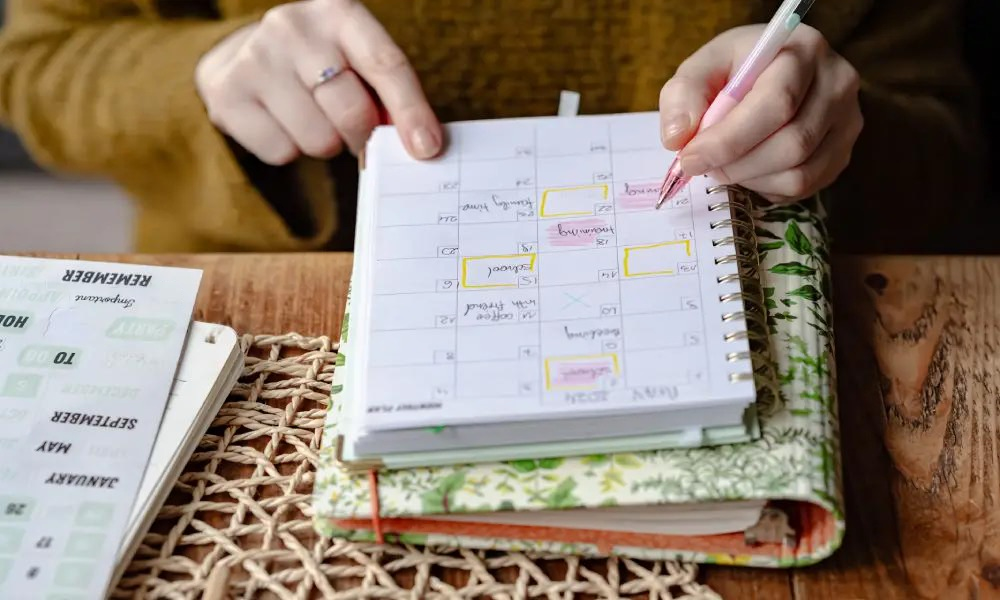 Woman writing appointments in planner

